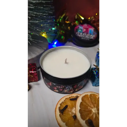 Open Christmas Nostalgia tin candle with dried orange slices and wrapped gifts