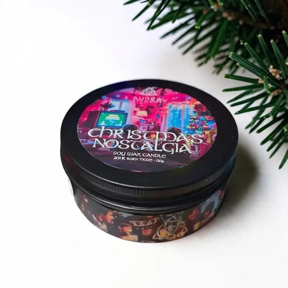 Christmas Nostalgia soy wax candle tin beside pine branches