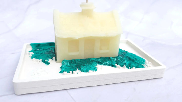 Cream beeswax Irish cottage candle on a white base with a green marbled pattern