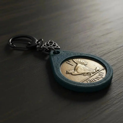 Irish penny keyring with a hen design and a Celtic knot charm on a dark wooden table