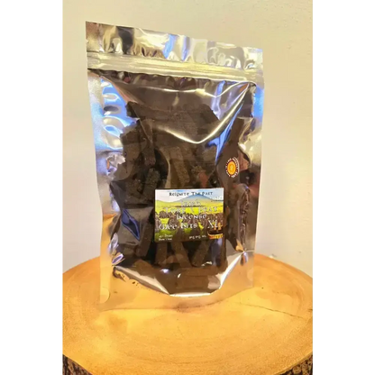 Silver resealable bag of Irish Turf Peat Incense Wee Bits on a wood slice