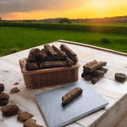 Small basket of turf sods and a sod on a slate on a table outdoors at sunset