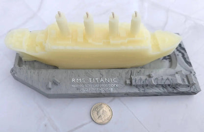 Titanic candle on its RMS Titanic base, with a coin beside it for scale