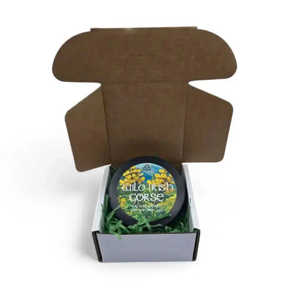 Wild Irish Gorse candle tin inside an open brown mailer box